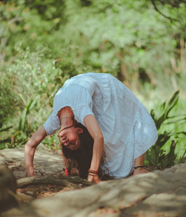 Woman in a calm yoga pose in a serene environment.